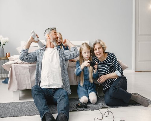 Family playing a console together at home